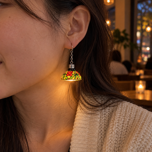 Floral lampshade earring switched on while worn, casting a warm glow