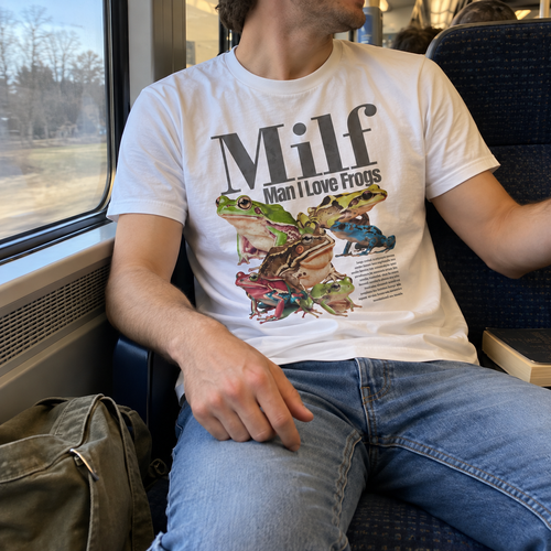 White frog graphic T-shirt on a train